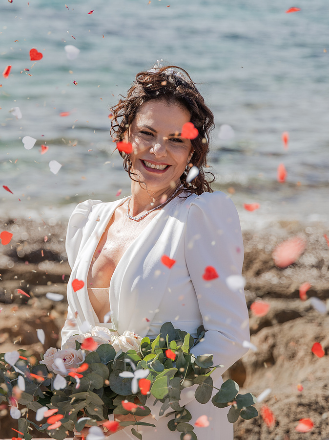 Bride laughing under a shower of confetti at a wedding in Ibiza and Formentera